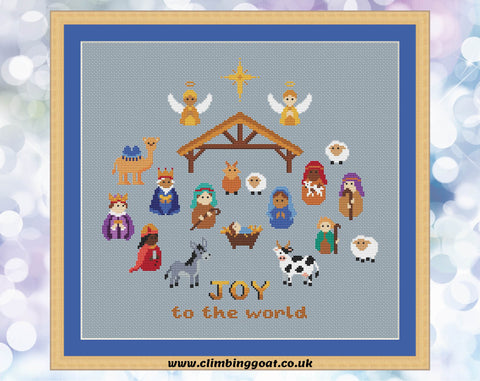 Nativity cross stitch pattern. Cute characters portraying the whole traditional Nativity scene. Shown on blue fabric.